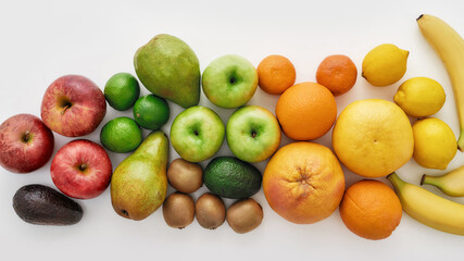 Top view of various colorful fresh summer fruits isolated over white background