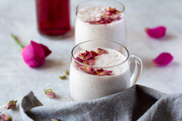 Moon milk with rose petals, healthy vegan drink in glass mug