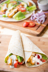 crispy chicken wrap on wooden board