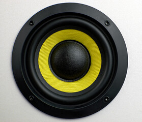 Subwoofer audio speakers. Subwoofer dynamic membrane or sound speaker. Yellow subwoofer, close up