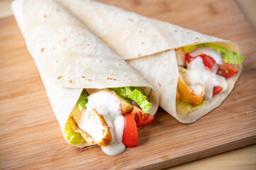 crispy chicken wrap on wooden board