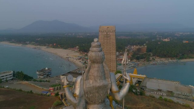 murudeshwar shiva statue back over head south india drone sunset round beach and sea