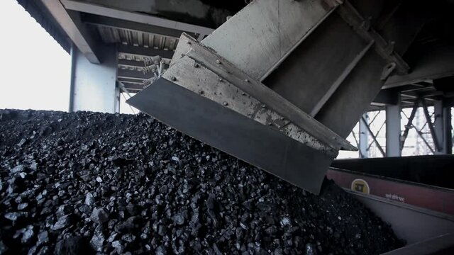 coal factory duping industrial raw material on train wide shot