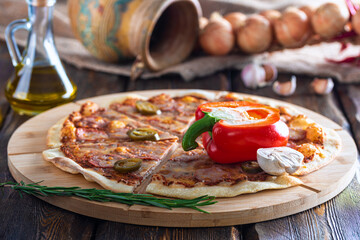 cutting board with hot tasty pizza and mushroom with pepper and oil bottle on wooden background,close view 