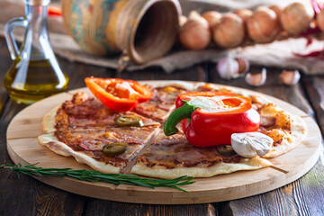 cutting board with hot tasty pizza and mushroom with oil bottle on wooden background,close view 