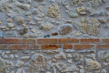 old wall texture made of stones, bricks and concrete. Old house and buildings