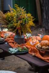 Fall themed holiday table setting arrangement for a seasonal party