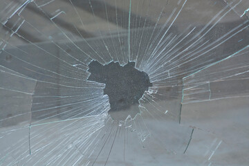 broken and shattered glass with many cracks and fragments