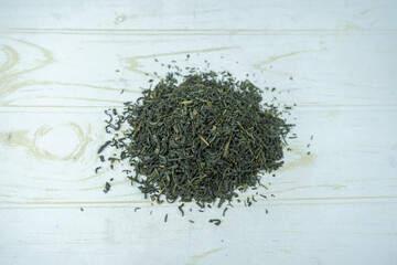 Fototapeta na wymiar Dry green tea pile on a table