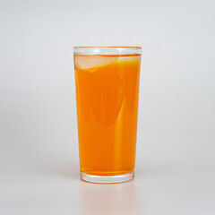 glass of orange juice with ice on a white background
