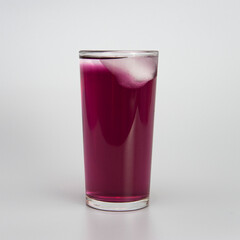 glass of juice with ice on a white background