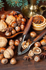 Christmas still life  with spices, nuts and dried oranges on wooden  background