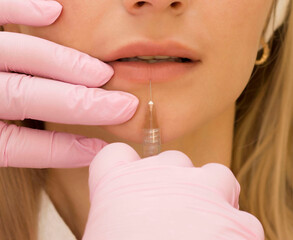 a young woman gets Botox injections. At a cosmetologist's appointment.