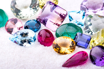 Group of gemstones on white sand.