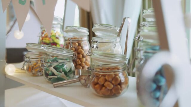 Close Up on candy bar stand at wedding with colourful candy in glases