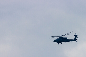 Fototapeta na wymiar Silhouette of military helicopter flying in daylight