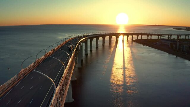 High-speed toll road, highway bypassing the city center St. Petersburg, the central section of the western high-speed section. A beautiful view of the sunset over the Gulf of Finland.