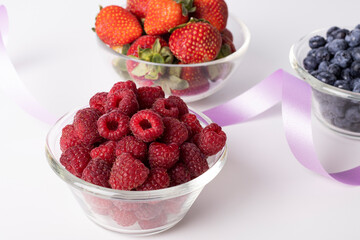Fresh raspberries, blueberries, strawberries on a white background