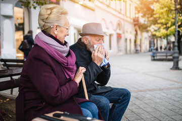 Senior couple in protective mask outdoors in the city. Air pollution concept.