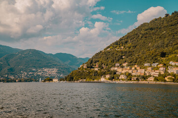 Panoramic sunset view of Lake Como, Lombardy, Italy with mansions and buildings in the hill