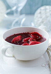 Traditional Christmas Borscht (Barszcz) with mushroom dumplings on bright background.	