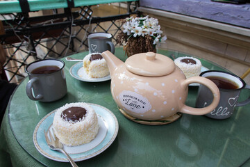 Teapot and teacup in vintage style. Tea time on the balcony