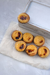 Traditional Portuguese popular dessert Pastel de nata or Pastel de Belem. Delicious puff pastry cups with custard. Vertical orientation.