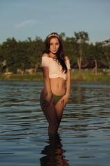 Portrait of pretty sexy woman standing in water