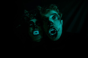 Halloween loving couple. Halloween couple. Dark background. 