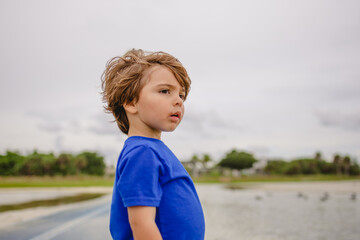 Boy playing on the beach at siesta Key florida with the snd and birds 