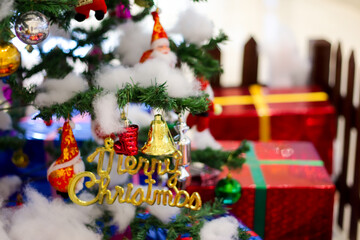 christmas decoration with gift bells balls boxes boots stars with christmas tree and cotton with blurred background