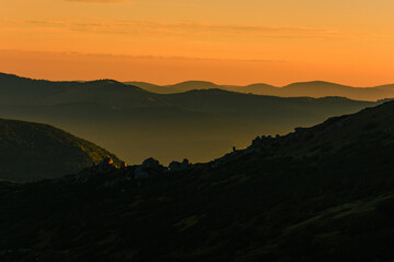Fog or haze at sunrise in the Carpathians, Ukrainian Pip Ivan and sunrise near Montenegro, picturesque mountain landscapes.