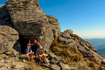 Family on one of the peaks of the Ukrainian Carpathians, parents and children admire the views of the Carpathians from Mount Smotrych, the Montenegrin ridge, rocky peaks in the Carpathians.