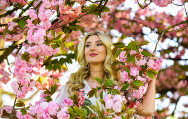 Spring symbol. Girl enjoy sakura in garden. Reasons why flowers always make women happy. Happy spring day. Harmony and female energy. Cherry tree. Good vibes. Floral aroma. Spring blossoming tree