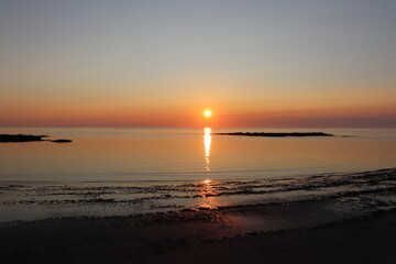 Early morning sunrise with reflection on the sea
