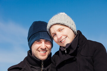 Portrait of young couple in winter against sky