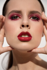 Fashionable portrait of a girl with bright makeup. red lipstick and red eyeshadow