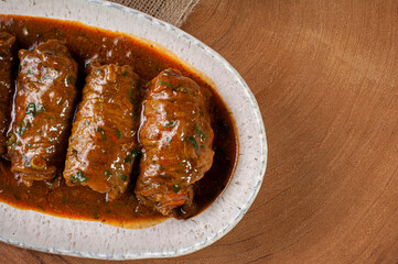 .Roll steak in delicious tomato sauce. Top view. Copy space