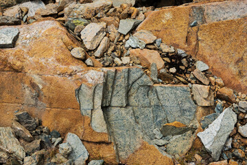 Green Serpentine rock, a thin layer on the outside colored reddish due to forming of iron oxide