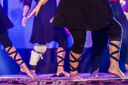 Feet Of A Dancer On Stage Doing Hip Hop Dancing Stance With Background Neon Lights