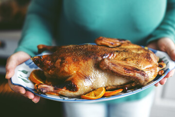 Woman cooking duck with vegetables