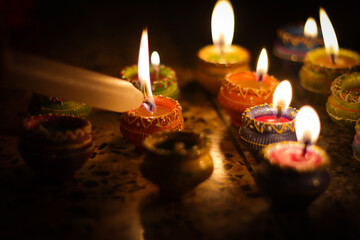 earthen diya lamp lighting with candles on the occasion of diwali and sandhi pujo