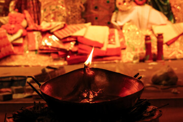 oil lamp lit as an offering to hindu god for worship with selective focus and blurred background
