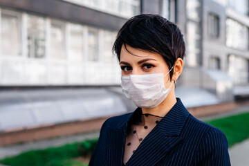 Woman wearing medical face mask for protection outdoors walking