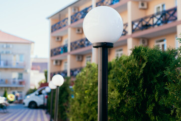 white garden lamp stands outdoors