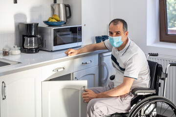 Young man wearing face mask sitting in front of kitchen