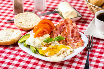bacon and eggs with avocado and tomato, bread and coffee