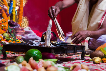 hand of a priest worshiping hindu god with fire and yagna ritual