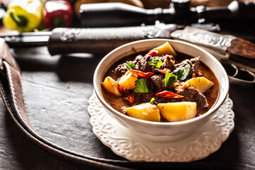 Deer stew in a bowl hunting weapon as a decoration
