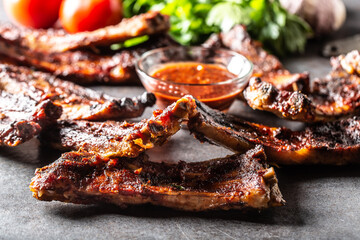 Baked glazed bbq ribs with a chilli sauce on the side
